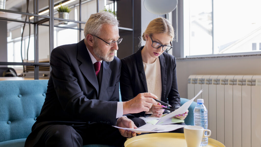 Two businesspeople discussing contract office